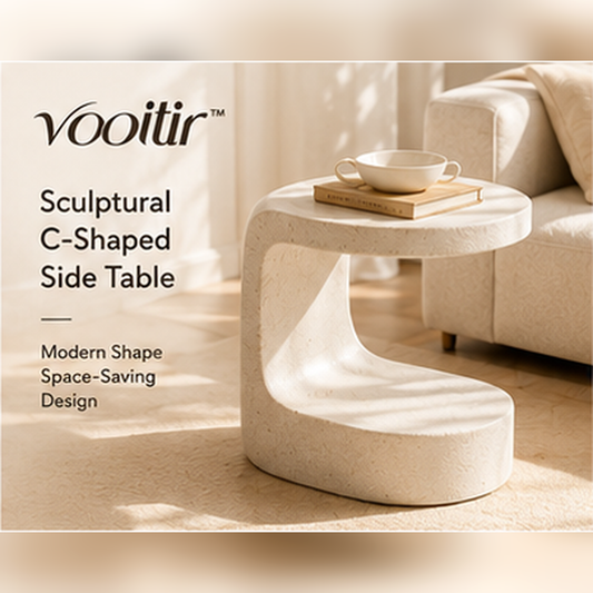 𝒗𝒐𝒐𝒊𝒕𝒊𝒓 cream sculptural C-shaped side table beside a neutral sofa